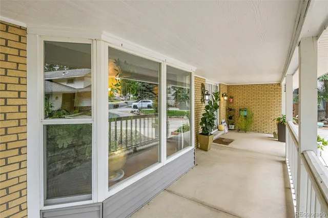 a spacious bedroom with a large window and a balcony