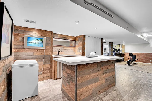 a kitchen with stainless steel appliances granite countertop a sink and wooden cabinets
