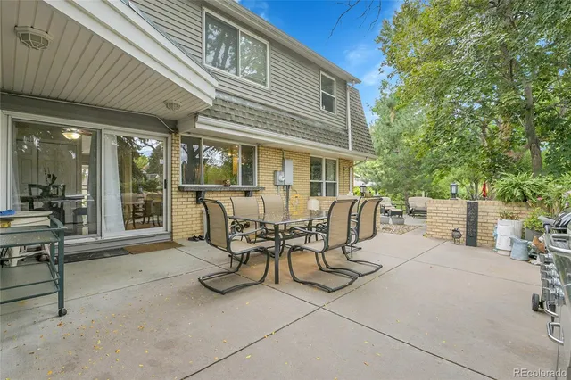 a view of a patio with table and chairs and potted plants