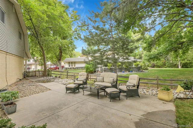 a view of a patio with table and chairs and couches