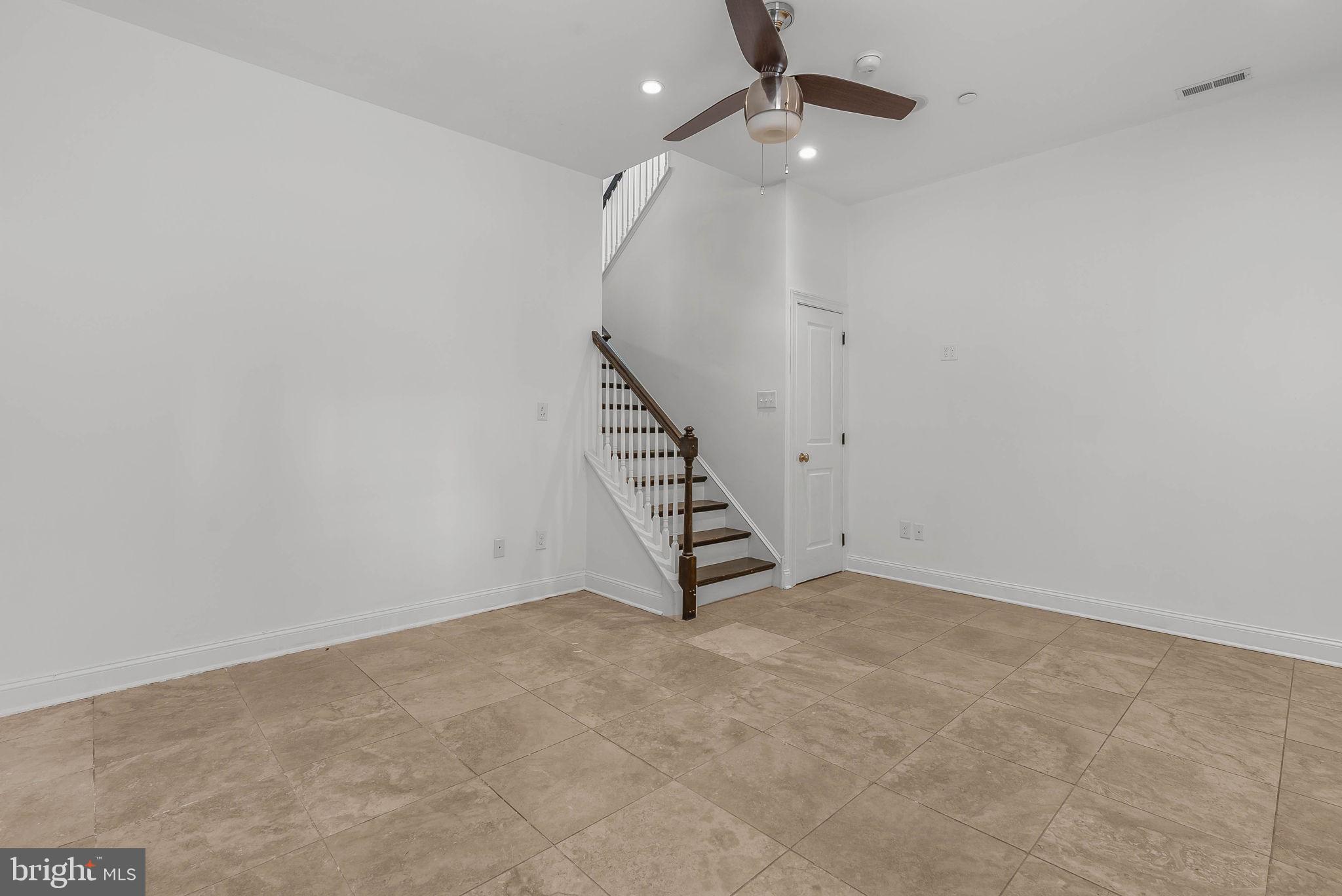 1015 North 3rd Street, Unit H Philadelphia, PA 19123 - Photo 23 of 27 an empty room with staircase and white walls