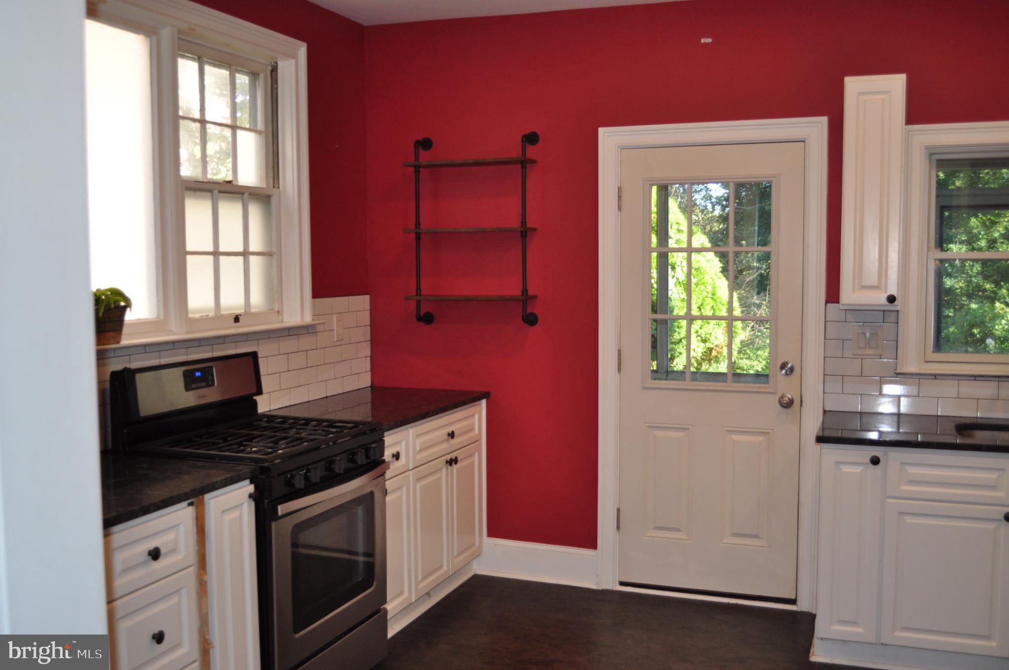256 Chestnut Street Spring City, PA 19475 - Photo 4 of 12 a kitchen with granite countertop a sink stove and cabinets