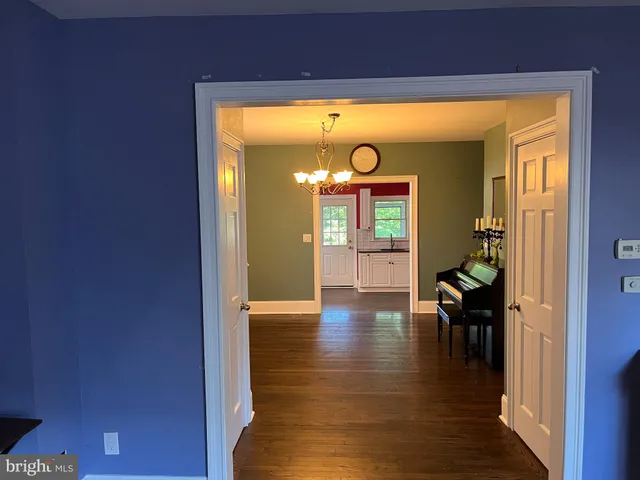 a view of a porch with wooden floor and a yard