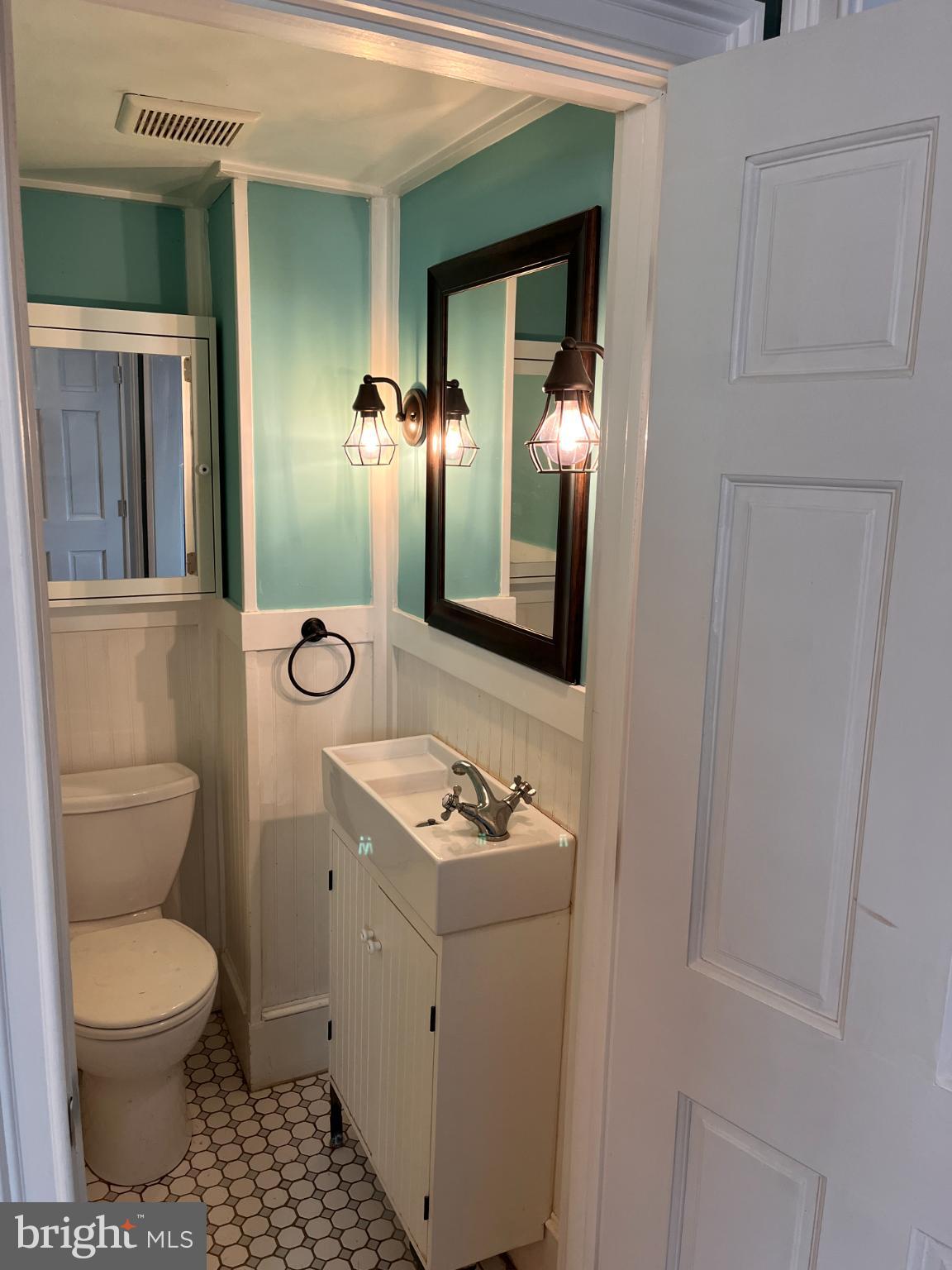 256 Chestnut Street Spring City, PA 19475 - Photo 10 of 12 a bathroom with a toilet a sink and mirror