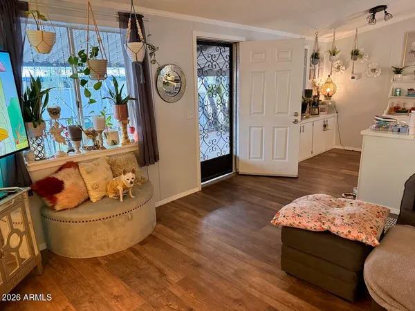 a living room with furniture and wooden floor