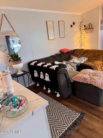 a bedroom with a bed dresser and window