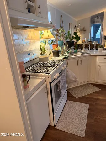 a kitchen with a stove a sink and a refrigerator