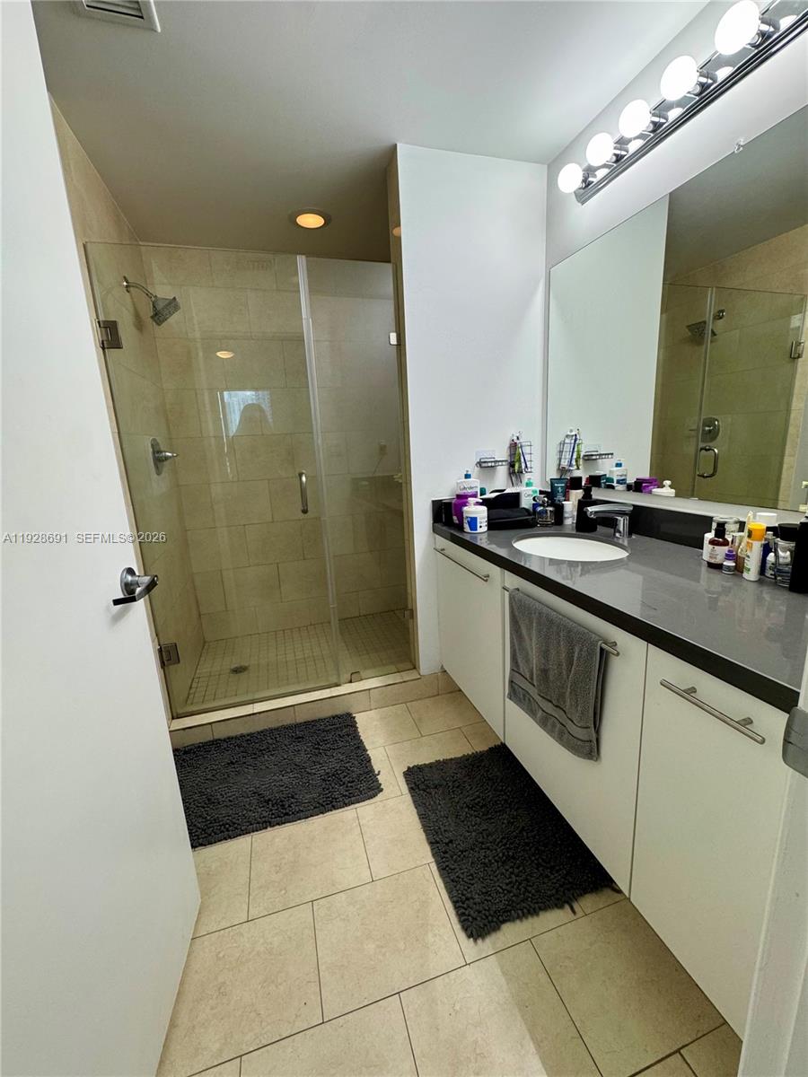 90 Southwest 3rd Street, Unit 3112 Miami, FL 33130 - Photo 13 of 42 a bathroom with a sink a toilet a mirror and shower