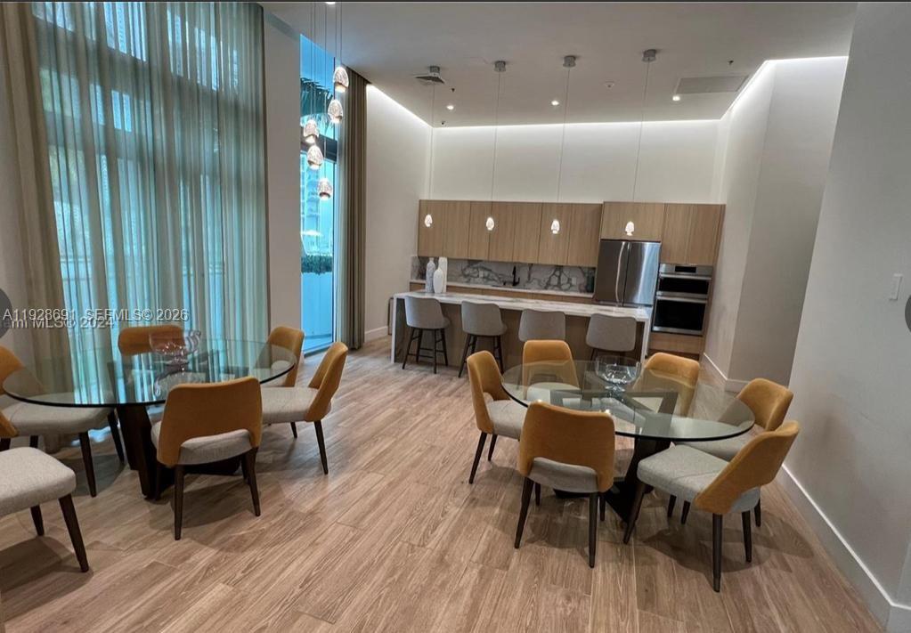 90 Southwest 3rd Street, Unit 3112 Miami, FL 33130 - Photo 20 of 42 a view of a dining room with furniture and wooden floor