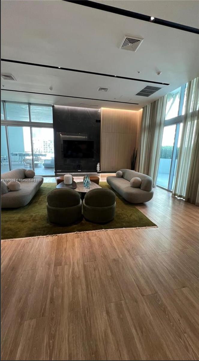 90 Southwest 3rd Street, Unit 3112 Miami, FL 33130 - Photo 24 of 43 a living room with furniture and a flat screen tv