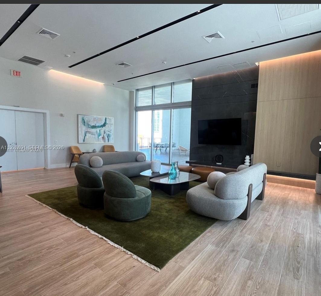 90 Southwest 3rd Street, Unit 3112 Miami, FL 33130 - Photo 25 of 42 a living room with furniture and a flat screen tv