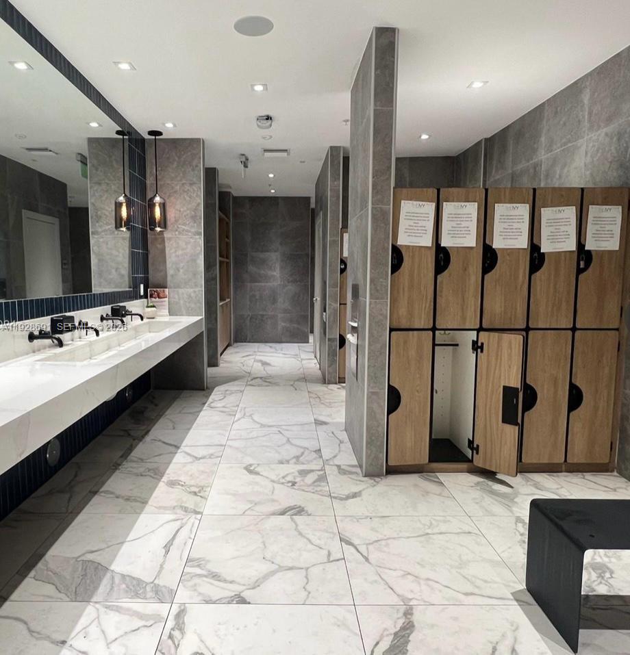 90 Southwest 3rd Street, Unit 3112 Miami, FL 33130 - Photo 39 of 42 a large room with gym equipment and a large mirror