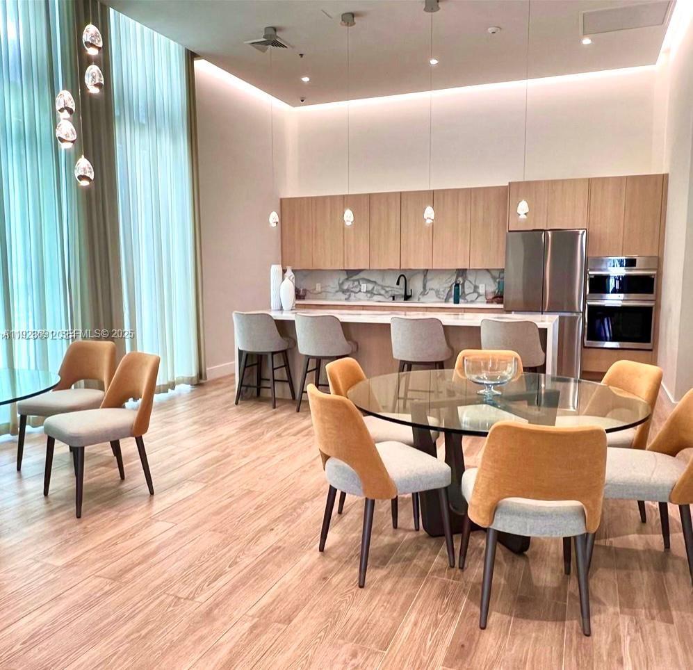 90 Southwest 3rd Street, Unit 3112 Miami, FL 33130 - Photo 41 of 43 a dining room with furniture and wooden floor