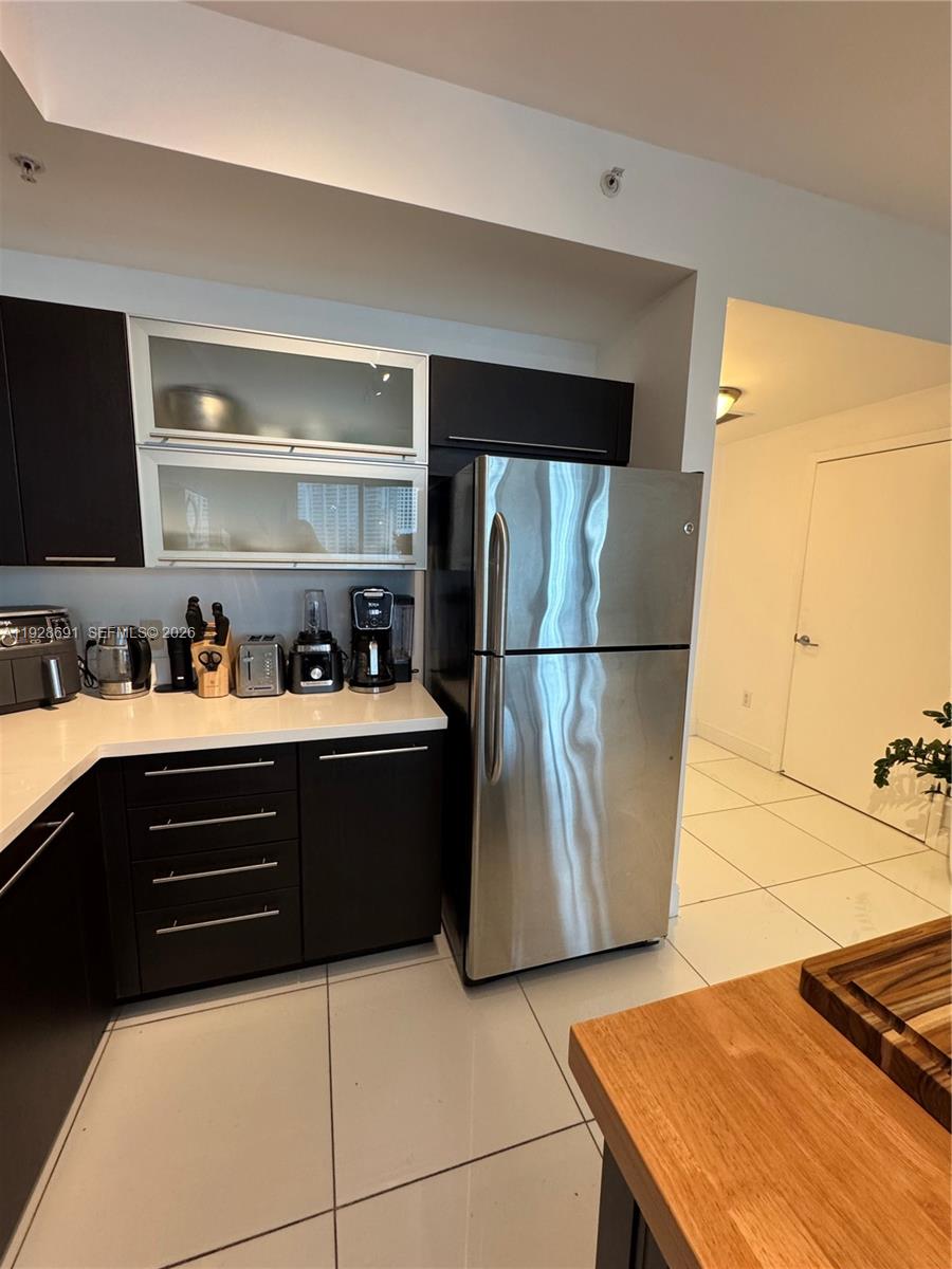 90 Southwest 3rd Street, Unit 3112 Miami, FL 33130 - Photo 9 of 42 a kitchen with a refrigerator and a sink