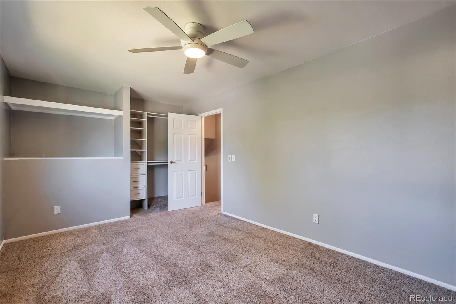 14808 East Tufts Avenue Aurora, CO 80015 - Photo 11 of 25 an empty room with closet and fan