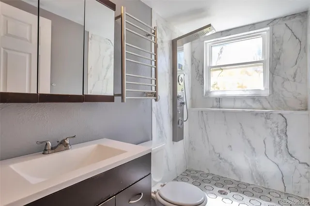a bathroom with a sink toilet and tub