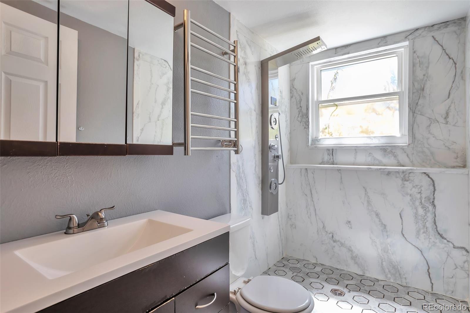 14808 East Tufts Avenue Aurora, CO 80015 - Photo 14 of 25 a bathroom with a sink toilet and tub