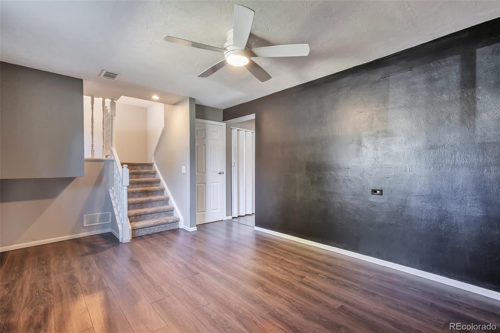 14808 East Tufts Avenue Aurora, CO 80015 - Photo 16 of 25 wooden floor in an empty room with a window