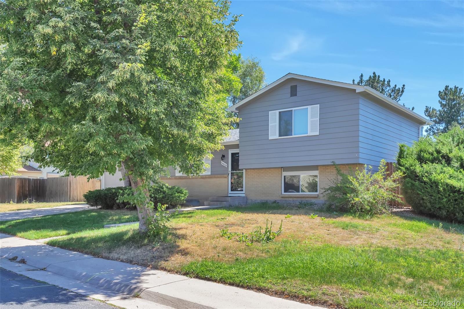 14808 East Tufts Avenue Aurora, CO 80015 - Photo 2 of 25 a front view of a house with garden