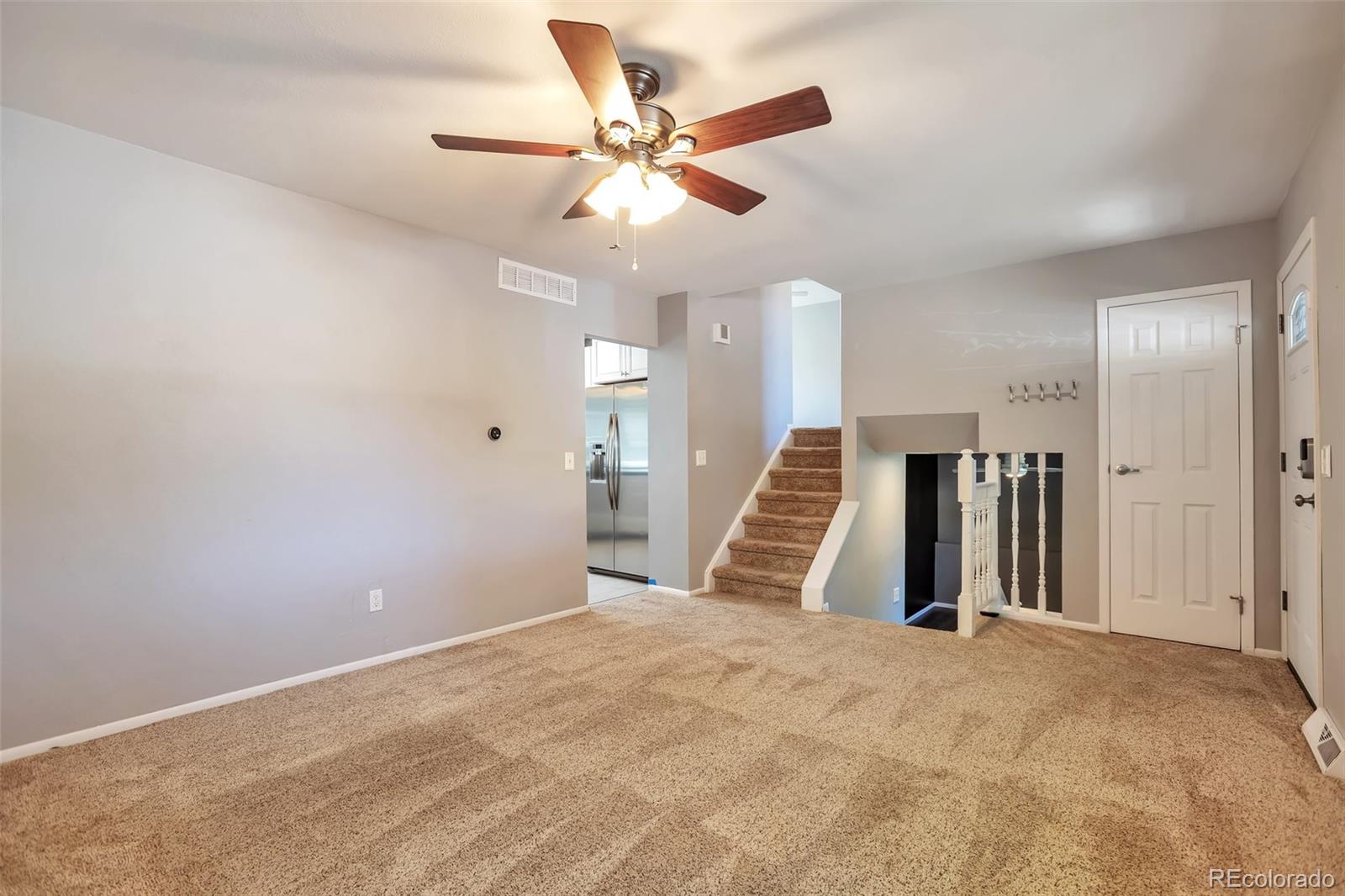 14808 East Tufts Avenue Aurora, CO 80015 - Photo 3 of 25 a view of an empty room with wooden floor