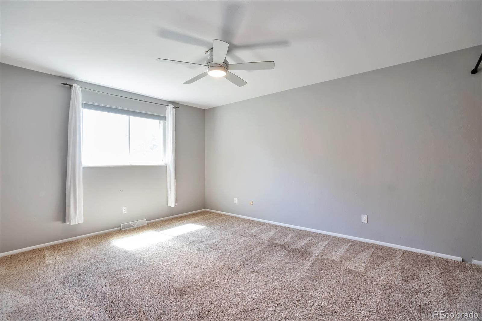 14808 East Tufts Avenue Aurora, CO 80015 - Photo 10 of 25 an empty room with windows and fan