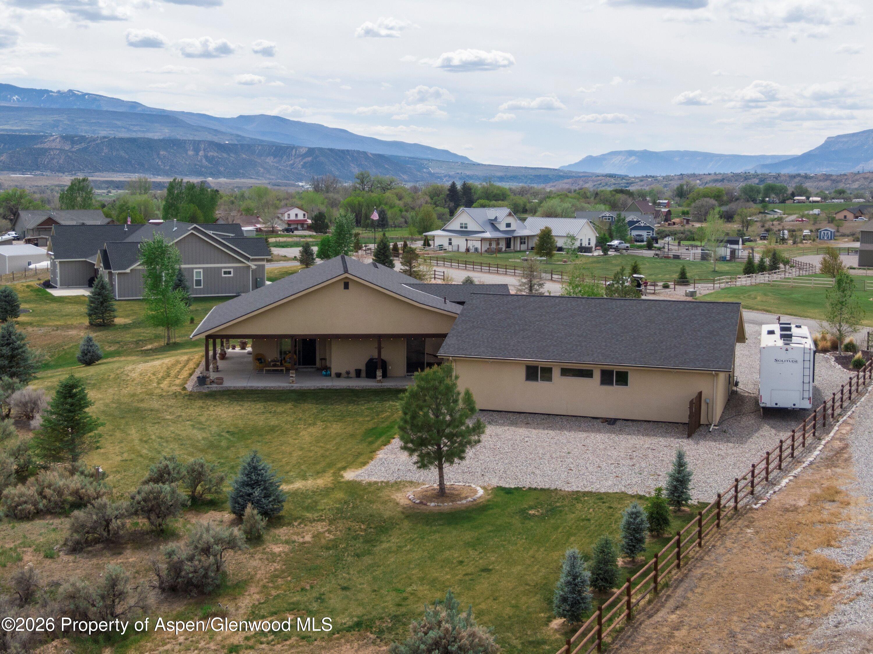 265 South Meadow Drive Rifle, CO 81650 - Photo 22 of 76 a aerial view of a house with a yard and lake view