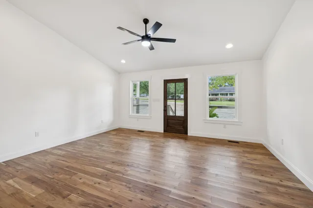 a kitchen with a table chairs sink and cabinets