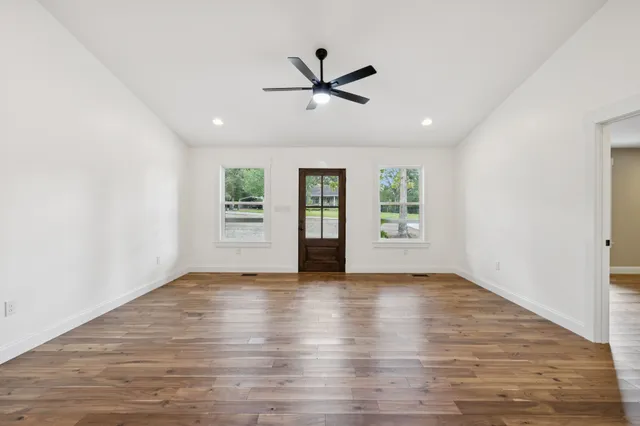 a kitchen with a stove and wooden floor