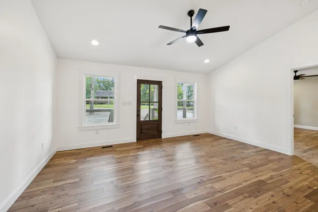 a kitchen with kitchen island granite countertop a sink cabinets a refrigerator and a stove