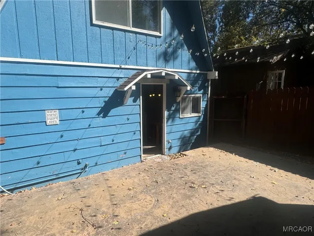 a view of a house with a wooden fence