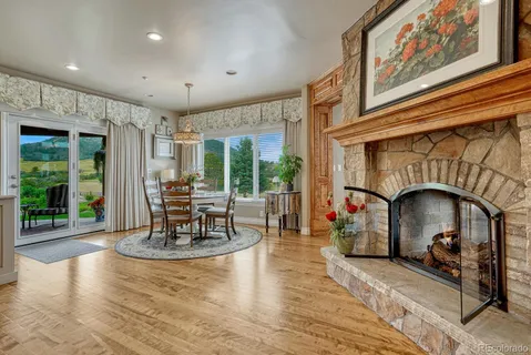 a living room with fireplace furniture and a large window
