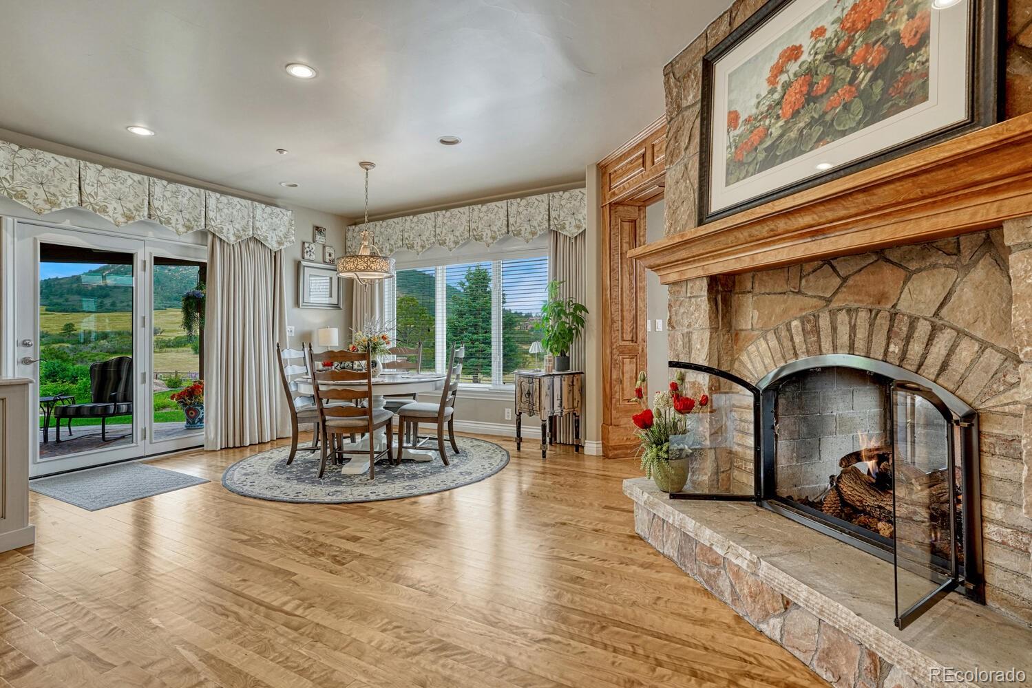 3851 Castle Butte Drive Castle Rock, CO 80109 - Photo 13 of 50 a living room with fireplace furniture and a large window