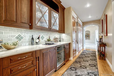 a kitchen with granite countertop lots of stainless steel appliances granite countertop a refrigerator and wooden cabinets