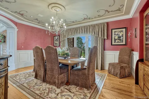 a view of a dining room with furniture and a chandelier