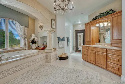 a bathroom with a tub sink and mirror