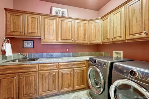 a utility room with granite countertop washer and dryer