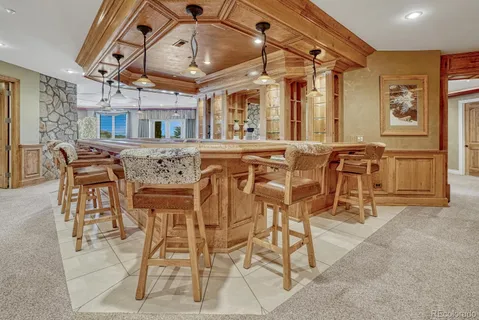 a view of a dining room with furniture and a chandelier