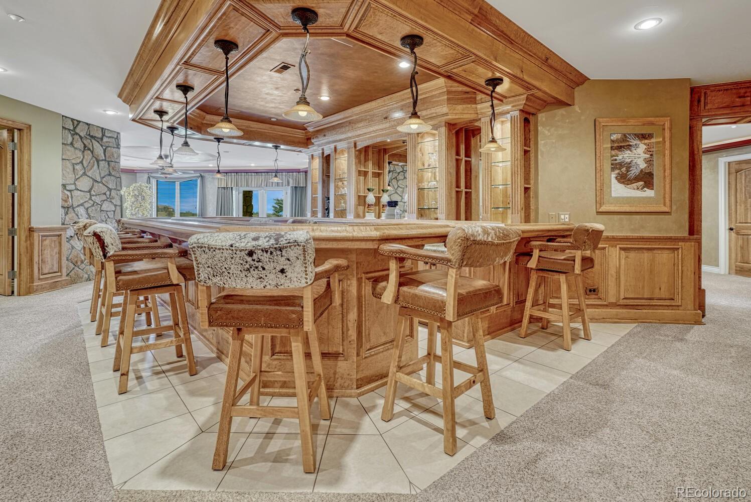3851 Castle Butte Drive Castle Rock, CO 80109 - Photo 27 of 50 a view of a dining room with furniture and a chandelier