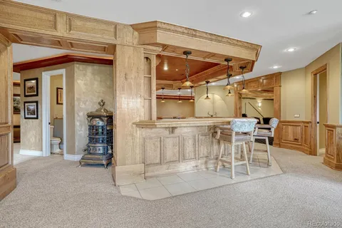 a view of a kitchen with table and chairs