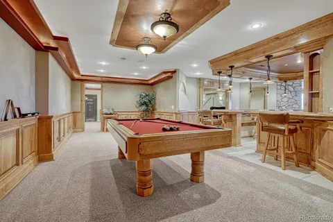 a room with table tennis pool table and chairs