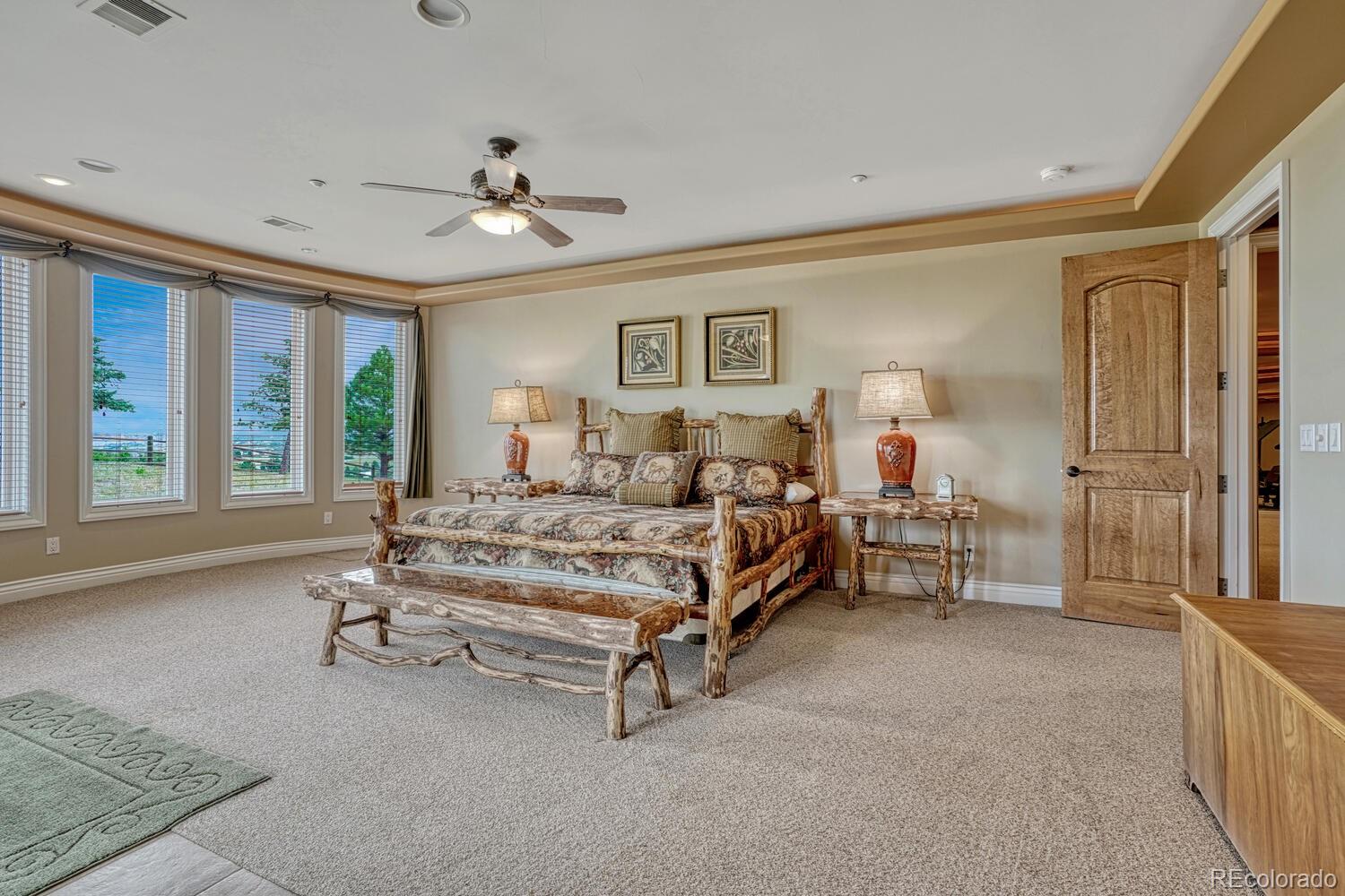 3851 Castle Butte Drive Castle Rock, CO 80109 - Photo 33 of 50 a spacious bedroom with a bed and a large window