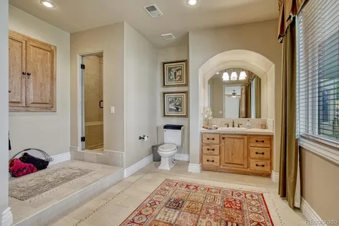 a spacious bathroom with a granite countertop sink mirror and vanity
