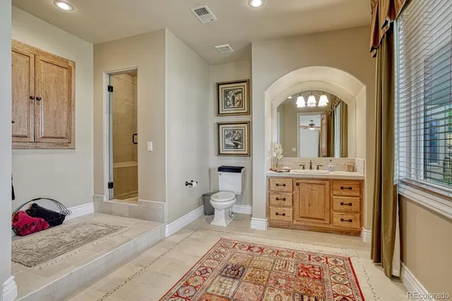 a spacious bathroom with a granite countertop sink mirror and vanity