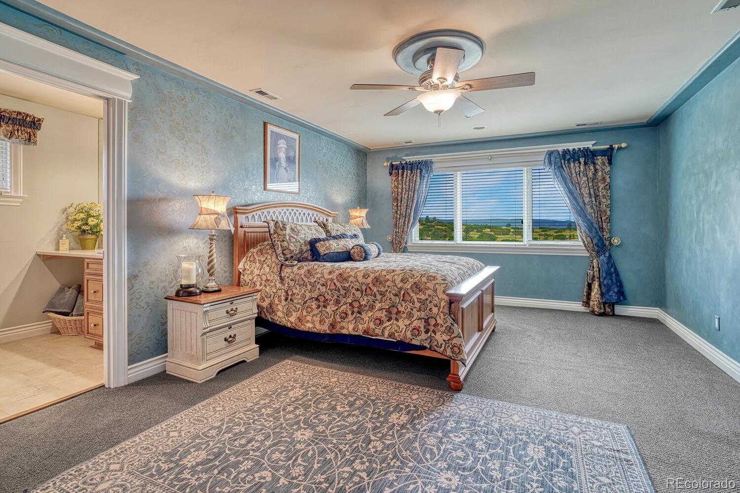 3851 Castle Butte Drive Castle Rock, CO 80109 - Photo 37 of 50 a bedroom with bed and window