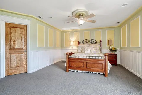 a spacious bedroom with a bed and chandelier