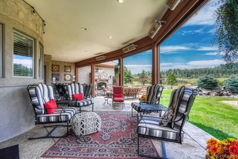 a living room with patio furniture and garden