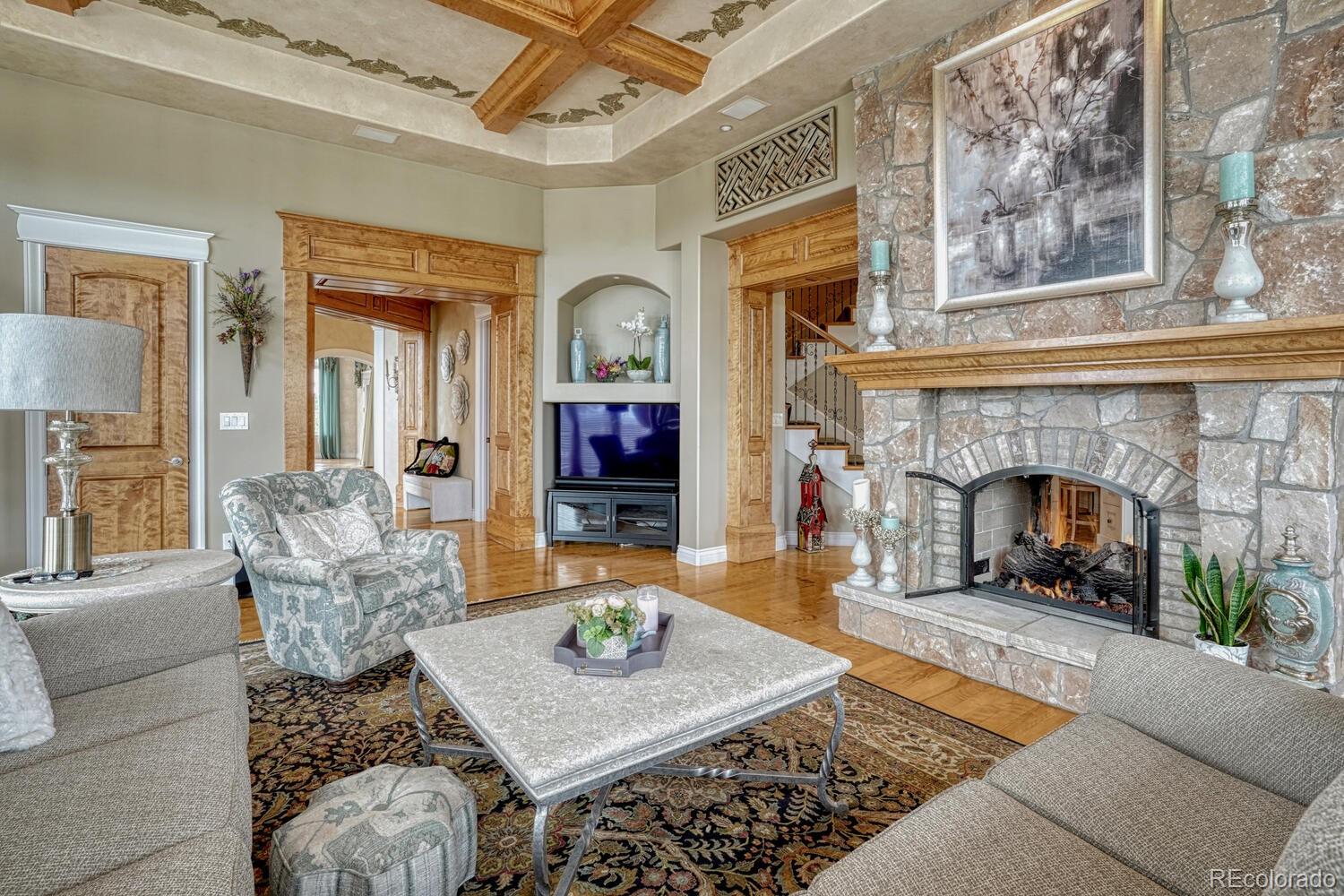 3851 Castle Butte Drive Castle Rock, CO 80109 - Photo 7 of 50 a living room with furniture and a fireplace