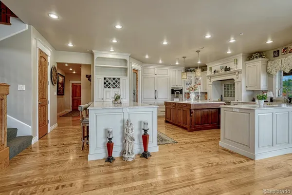 a view of kitchen with stainless steel appliances kitchen island granite countertop a refrigerator and a sink