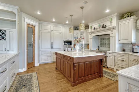 a kitchen with kitchen island granite countertop a stove and a refrigerator
