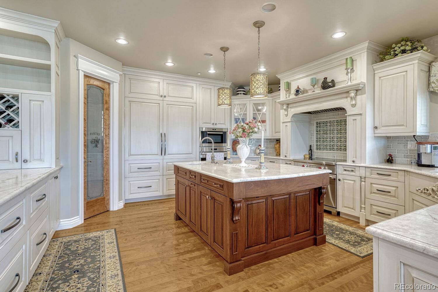 3851 Castle Butte Drive Castle Rock, CO 80109 - Photo 10 of 50 a kitchen with kitchen island granite countertop a stove and a refrigerator